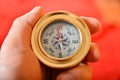 A man holds a compass in his hand for knowing the direction of the path, a traveler on the road learns the compass navigation Royalty Free Stock Photo