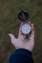 Man holds a compass in his hand. man wathing compass holding in his hands Royalty Free Stock Photo