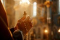 A man holds a cross in his hands and prays intently in a Christian church, AI generation Royalty Free Stock Photo