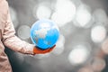 A man holds an earth shaped balloon in his red-hot hand, Artistic colors, Creative Ecological Concept, Global warming, Human