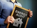 Man holds Energy Audit board