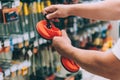 A man holds equipment for carrying glass in his hands. Concept man selects a product in a hardware store