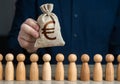 A man holds a euro money bag above the crowd. Deposits and loans. Salaries. Crowdfunding and fundraising. Budgetary funds for Royalty Free Stock Photo