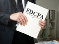 Man holds The Fair Debt Collection Practices Act FDCPA