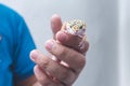 A man holds a friendly juvenile leopard gecko in his hand. A reptile lover, pet owner or herpetologist Royalty Free Stock Photo