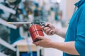 A man holds a gas burner in his hand. A buyer in a hardware store selects a product