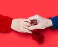 A man holds a girl`s hand. Marriage proposal. Close-up. Top view