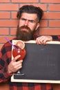 Man holds glass, brick wall background. Schedule concept. Royalty Free Stock Photo