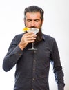 Man holds glass, cocktail with orange, margarita