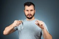 A man holds a glass of water and a pill, taking medication, treatment, gray background. Medical theme, vitamins, health care Royalty Free Stock Photo