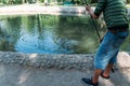 Close-shot of human hands holding a fishing-rod on the foreground.a man holds a fishing pole over the water, catches fish.cut fish Royalty Free Stock Photo