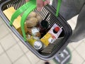 Minsk / Belarus / 05/09/2020:A man holds a grocery basket in a supermarket. A close-up. Mobile photo