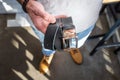 Man holds handmade black leather belt in his hand. Close-up, top view. Fashion and stylish accessories Royalty Free Stock Photo