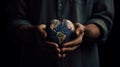Man holds heart-shaped globe, urging us to protect Earth\'s environment and natural systems.