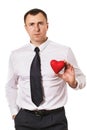 A man holds a heart-shaped toy in his hands, isolated on a white background Royalty Free Stock Photo