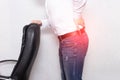 A man holds his back holding an office chair concept of back pain, pinched nerve and myofascial syndrome, inflammation, lumbago Royalty Free Stock Photo