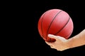 Man holds in his hand a basketball game ball Royalty Free Stock Photo