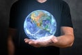 Man holds in his hand hologram of planet earth. man hold virtual hologram planet earth on hand. Concept of communication network, Royalty Free Stock Photo