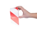 Man holds in his hand a protective signal tape with red stripes on a white background, isolate. Close-up, damage Royalty Free Stock Photo