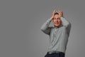 A man holds his hands on his head. The concept of frustration, horror, stress, hopelessness. Isolated on white Royalty Free Stock Photo