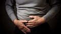 a man holds his hands in the lower abdomen, abdominal pain, no face Royalty Free Stock Photo
