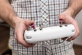 Man holds in his hands remote control for multicopter, indoors.