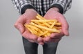 Man holds in his hands a tasty fries Royalty Free Stock Photo