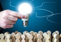 A man holds an idea light bulb above the crowd. Project leader. Teamwork. Brainstorming. Creativity. Informant. Statistics, survey