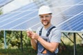 A man holds an Incandescent light bulb in his energy concept, the sun is clean after work and replaces the energy that Royalty Free Stock Photo