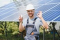 A man holds an Incandescent light bulb in his energy concept, the sun is clean after work and replaces the energy that Royalty Free Stock Photo