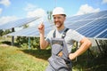 A man holds an Incandescent light bulb in his energy concept, the sun is clean after work and replaces the energy that Royalty Free Stock Photo