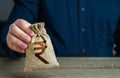 A man holds an indian rupee money bag. Deposits and savings.