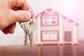 A man holds keys in the background of a new home. Sale and purchase of houses_ Royalty Free Stock Photo