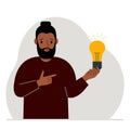 A man holds a light bulb in his hand. Idea concept, brainstorming, thinking, solution, eureka, task, bingo or search for