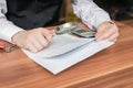 Man holds magnifying glass and is reading contract Royalty Free Stock Photo