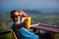 Man holds mango and passion fruit smoothies on tropical samui island in thailand in mountains Royalty Free Stock Photo