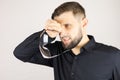 A man holds medical glasses in his hands on a white background