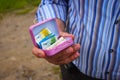 A Man Holds A Miniature Pink Suitcase With Chocolate And Real Euro Notes The Common Currency Of The European Union Royalty Free Stock Photo