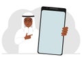 A man holds a mock-up of a large smartphone with a blank screen and with his second hand points to the screen of the