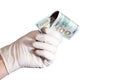 A man holds 100 dollars in the white gloves. Royalty Free Stock Photo