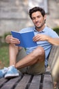 man holds notebook sitting on bench Royalty Free Stock Photo