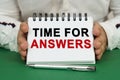 A man holds a notepad in his hands with the inscription - Time for Answers Royalty Free Stock Photo