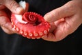 Man holds octopus tentacle