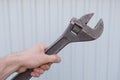 Man holds old adjustable wrench in the hand Royalty Free Stock Photo