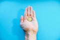 A man holds one coin in his palm, close-up. Fifty cents euro in hand, POV. Bankruptcy, poverty, falling income, low cost.