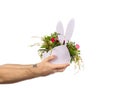 a man holds out a bouquet of flowers, decorated in a plywood vase in the shape of a hare. holidays, birthdays and Royalty Free Stock Photo