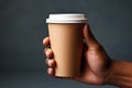 A man holds a paper cup for coffee in his hands, a mockup for manufacturers of branded cups for drinks. Royalty Free Stock Photo