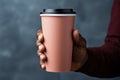 A man holds a paper cup for coffee in his hands, a mockup for manufacturers of branded cups for drinks. Royalty Free Stock Photo