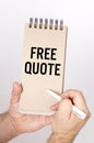A man holds a pen and a bolknot in his hands with the inscription - Free Quote