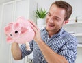 Man holds piggy bank